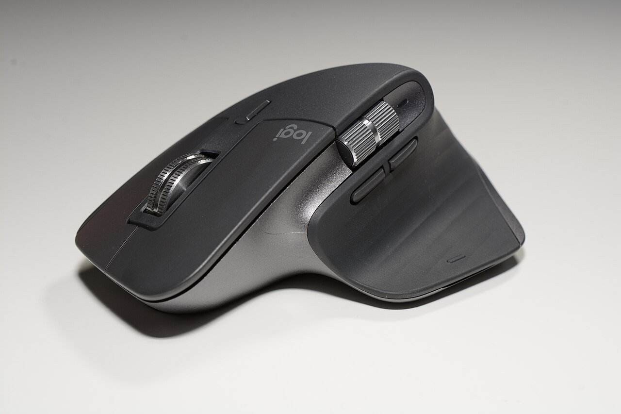 Close-up of a dark Logitech MX Master 3S showing its broad curved button shell and fine seams